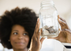 Woman looking at savings jar