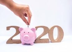 Dropping coin into piggy bank 2020