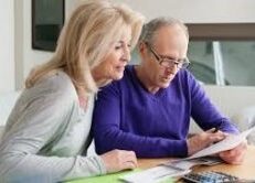 Middle aged couple working on home finances